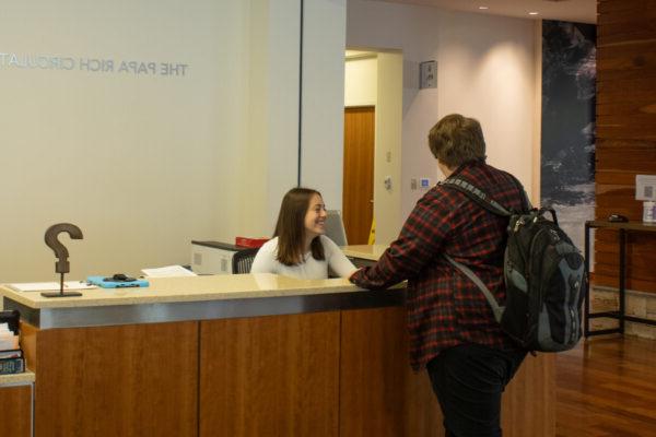 Student at service desk in library