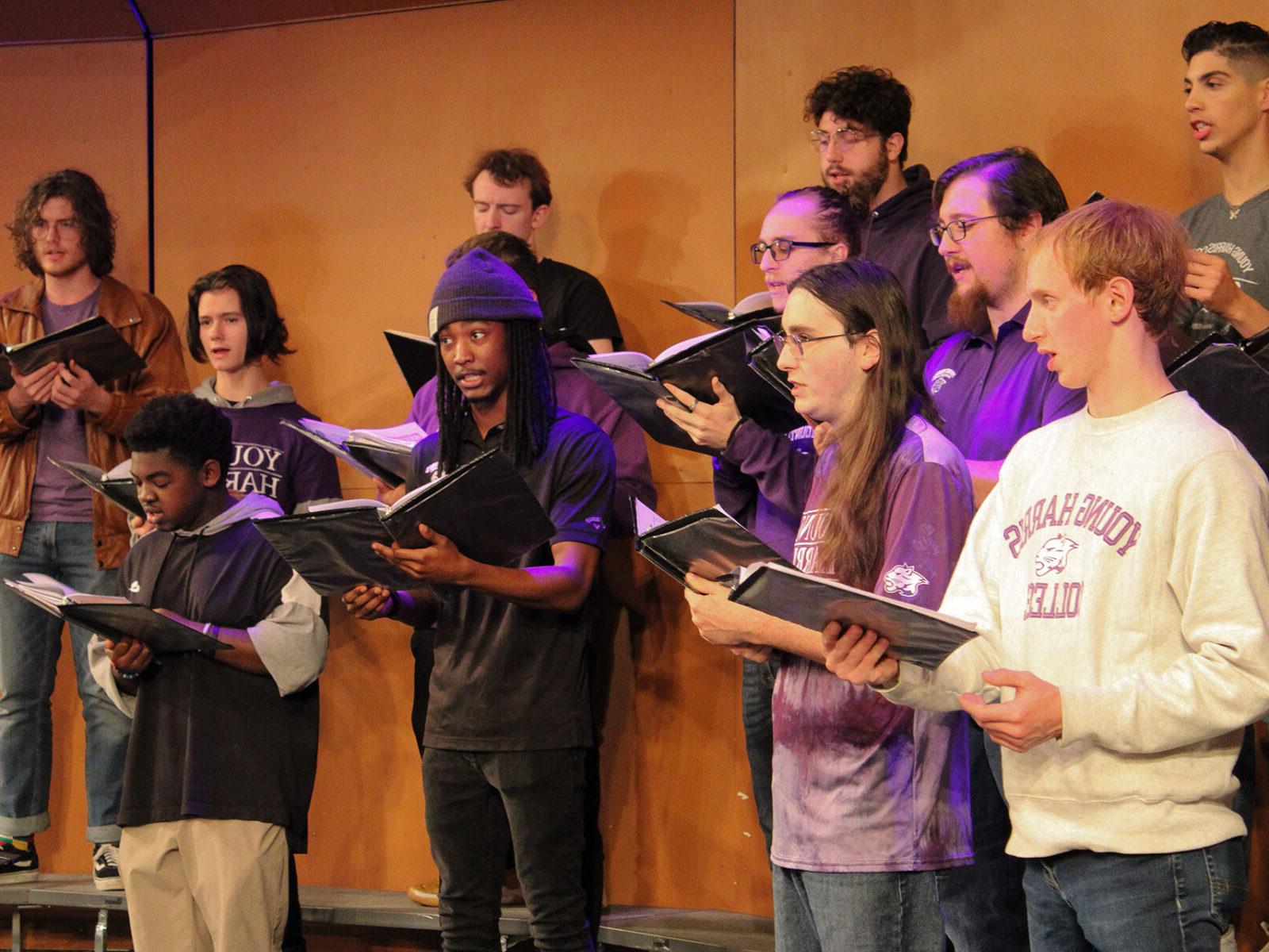 a group of people singing on stage